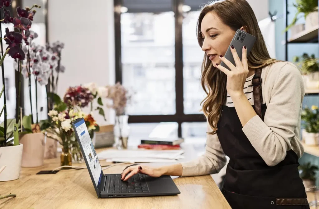 Lenovo ThinkPad X1 Carbon Gen 12 laptop on a desk, showcasing its premium design and thin profile.