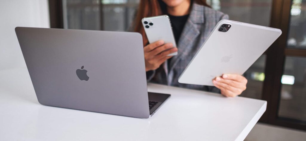 A collection of Apple devices, including an iPhone, MacBook, iPad, Apple Watch, and AirPods, demonstrating seamless connectivity within the Apple ecosystem."