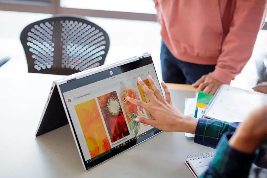 Student using an HP Pavilion x360 laptop for studying and productivity.