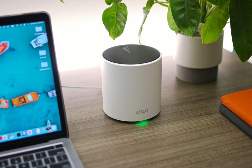 A sleek, modern TP-Link Archer series Wi-Fi 6 router with multiple antennas, positioned on a desk in a home office setup, symbolizing robust connectivity.