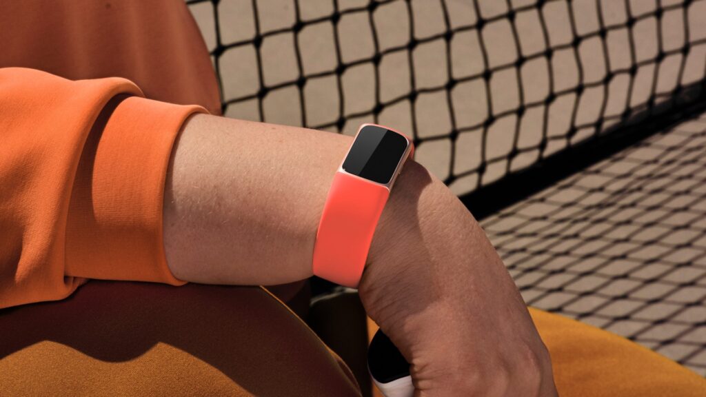  Fitbit Charge 6 on a wrist displaying the time, highlighting its sleek and comfortable design for everyday wear.