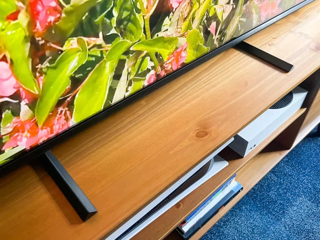 Vizio Review: Best Budget TVs with Smart Features? A Vizio 4K TV screen showing a lush green forest with a clear blue sky, emphasizing vibrant colors and high detail.