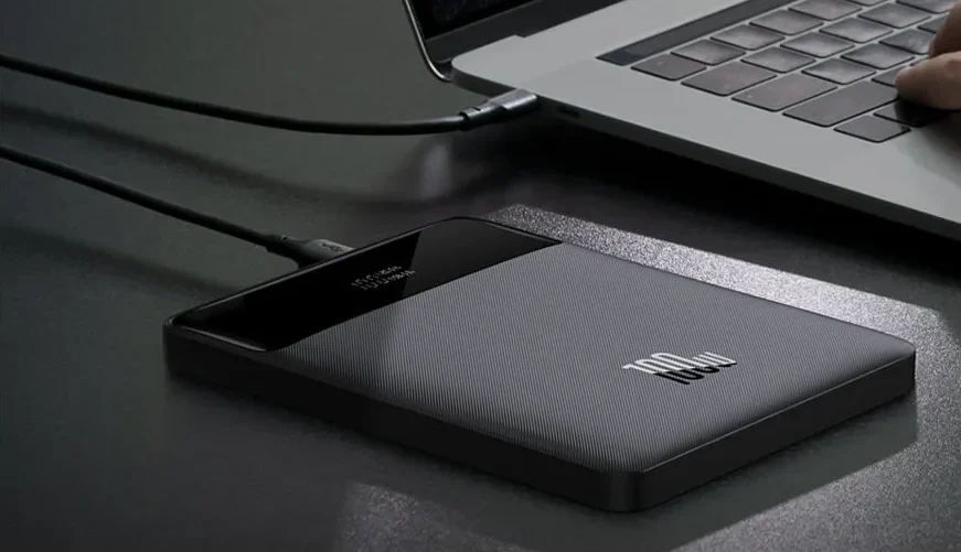 Slim Baseus Blade power bank charging a laptop on the go