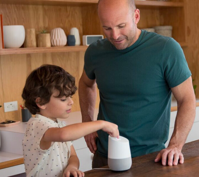 Family enjoying a smart kitchen, children safely interacting with voice-controlled appliances