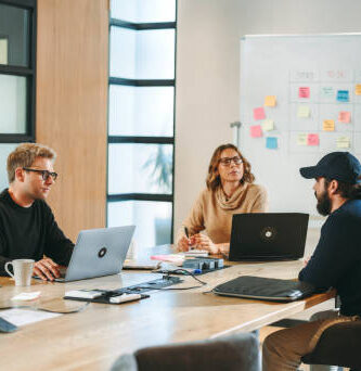 Business leaders collaborating and leveraging emerging technologies for strategic growth in 2025.