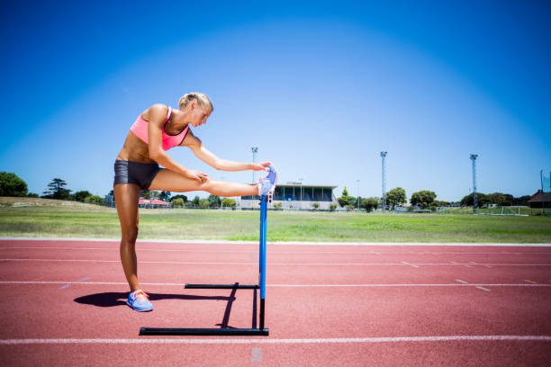 An athlete, mid-action, wearing sleek, form-fitting smart athletic wear with visible, subtle tech integrations designed for performance monitoring