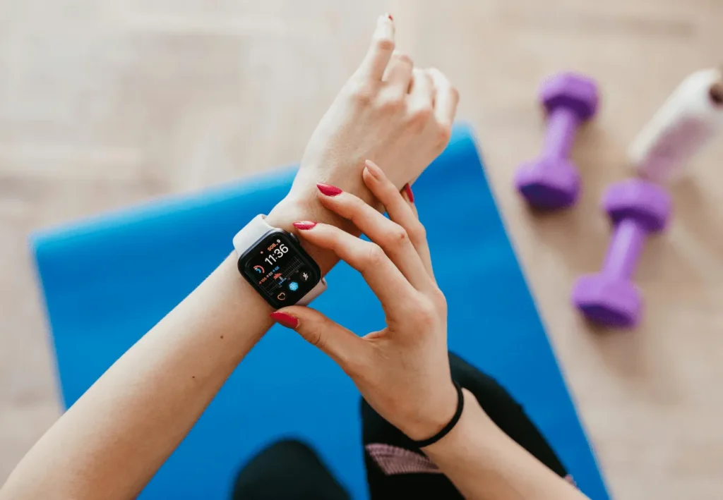 Wearable Tech in 2025: Your Guide to Smartwatches, Rings, and Beyond A diverse group of people using different types of wearable tech, including a smartwatch, smart ring, and fitness earbuds.