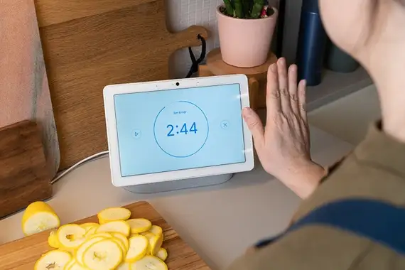  A person using an Amazon Echo Show to view a live feed from their smart security camera, demonstrating seamless home automation