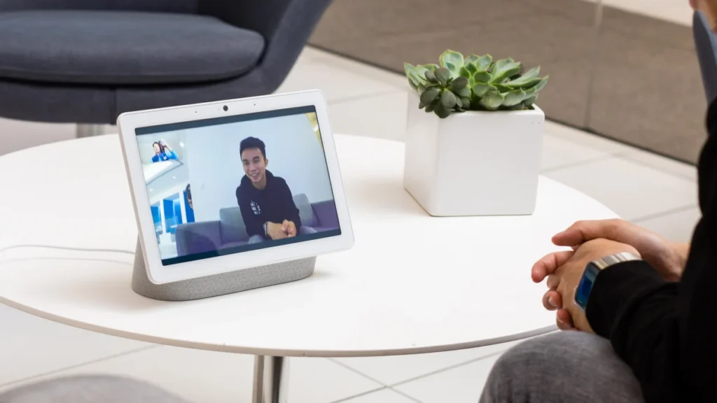  Google Nest Aura smart hub on a modern desk, surrounded by other connected devices, illustrating a smart home setup