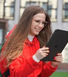 iPad vs Android Tablets: Which Tablet Should You Buy in 2025? A person taking handwritten notes on an iPad with an Apple Pencil in a study environment, illustrating its use for students.
