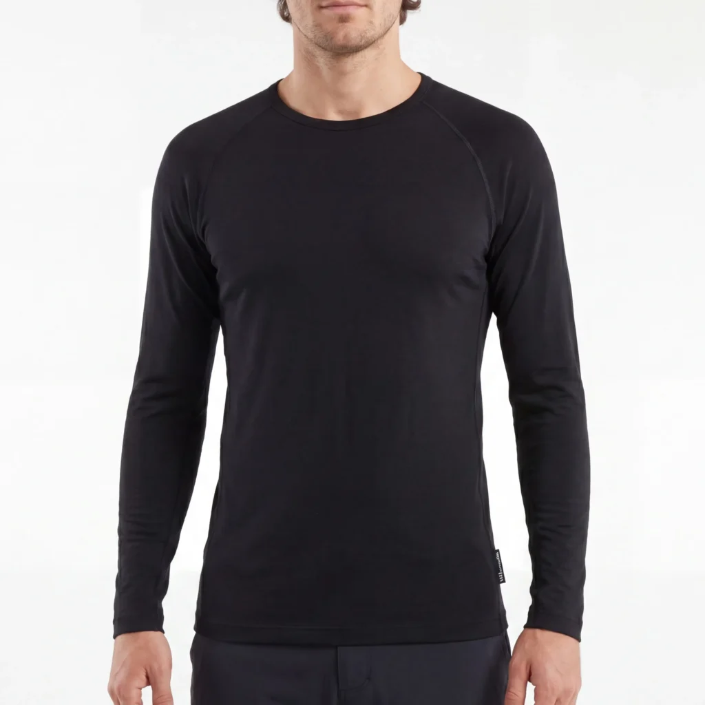 A men wearing a fitted black long-sleeve crew neck base layer shirt against a plain white background.